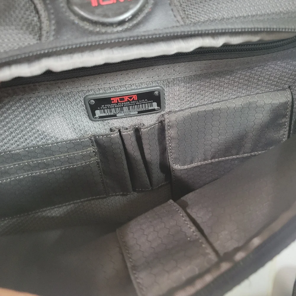 TUMI Black Backpack with Padded Straps and Multiple Compartments